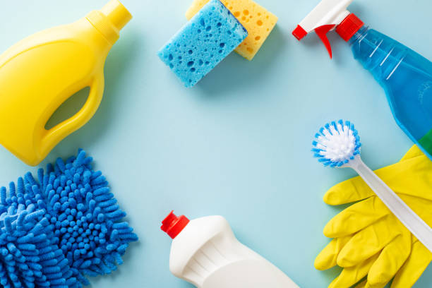 istock Home cleaning essentials showcased on pastel blue backdrop. Top view image featuring scrub brush, sponges, gloves, detergents, sprayerâ perfect depiction of cleanliness. Empty space for your message 1975265309