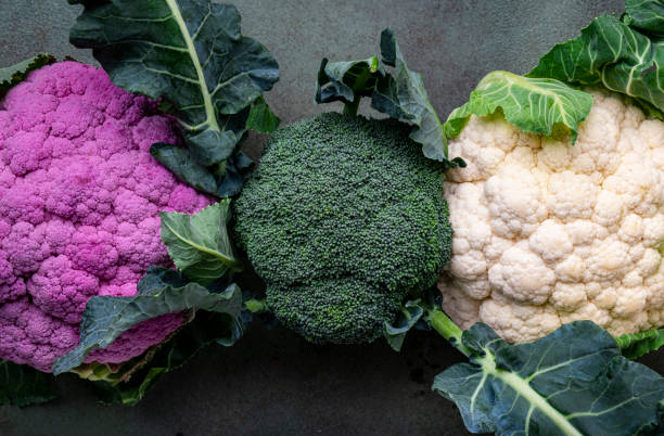 istock White and lilac cauliflower, broccoli cabbage from farm market on old rustic green table 1975275961