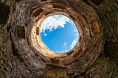 Izborsk, Russia, September 7, 2023. Blue sky through the round hole of the old tower.