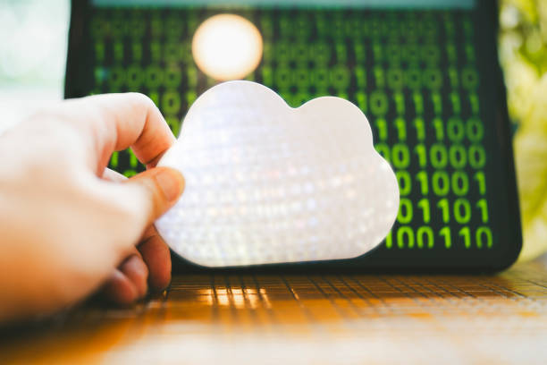 A person holds a symbol of a cloud, which indicates the cloud computing system and the data in it.