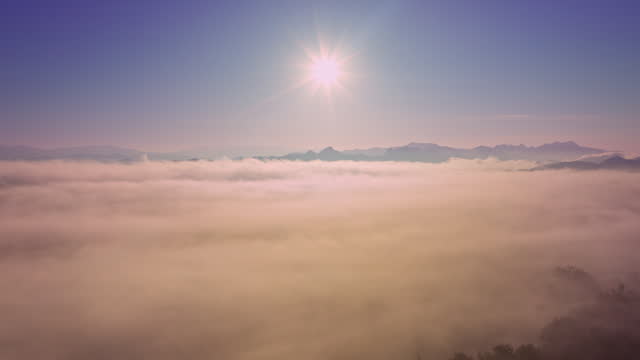 Aerial hyper lapse view amazing sun shine above the sea of Mist