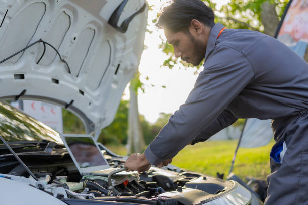istock maintenance concept Asian auto mechanic or smith writing on clipboard at warehouse workshop Technician making checklist for car repair Roadside breakdown and insurance concept 1975324050