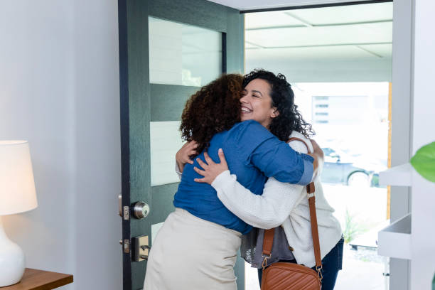 istock Two women embrace one another 1975342001