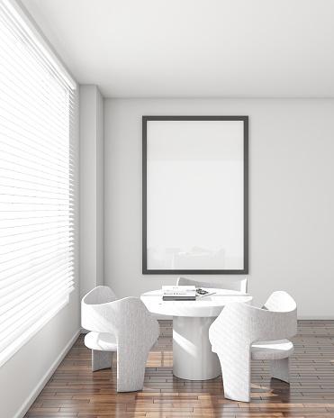 Minimalist styled meeting room with natural light. Features a white round table, modern grey chairs, herringbone wood floor, and a large framed blank canvas on the wall. 3D render