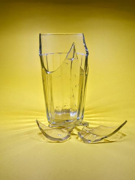 istock Shards of a broken glass on a yellow background 1975366318