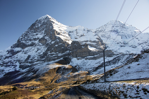 A picture of the Eiger north face in autumn with the Wengernalpbahn railtrack in the foreground