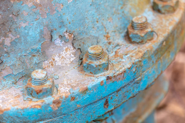Rusty bolts on a metal pipe.