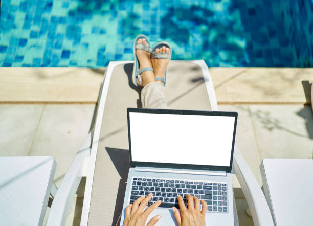 istock top view woman working on laptop computer by the pool, hands typing keyboarding text 1975383436