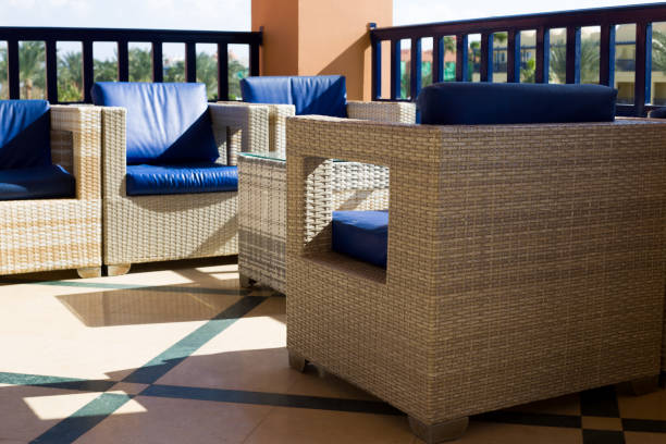 Wicker chairs with armrests and soft cushions