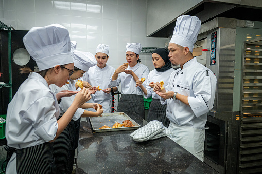 Rising to Perfection: Bread Baking with the Asian Chef - Head Asian chef and a  group of students tasting baking bread during cooking class