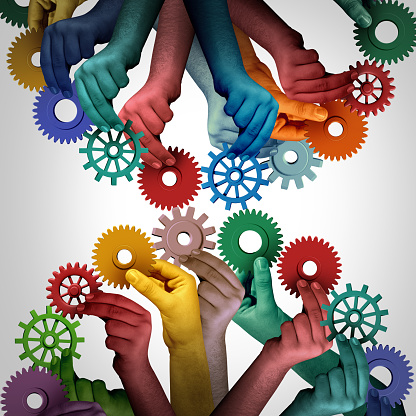 United employees and worker unity as a group of diverse people using gears and cogs to connect as a strong collaborative company working together as connected team.