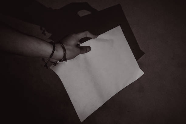 Shocked young woman reading letter while touching head at home
