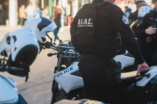 Hellenic Police, Greek police squad on duty riding bike and motorcycle, maintain public order in the streets of Athens, Attica, Greece, group of policemen with Greek Police logo emblem on uniform