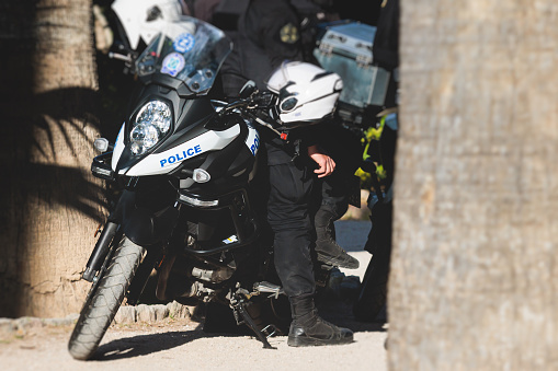 Hellenic Police, Greek police squad on duty riding bike and motorcycle, maintain public order in the streets of Athens, Attica, Greece, group of policemen with Greek Police logo emblem on uniform