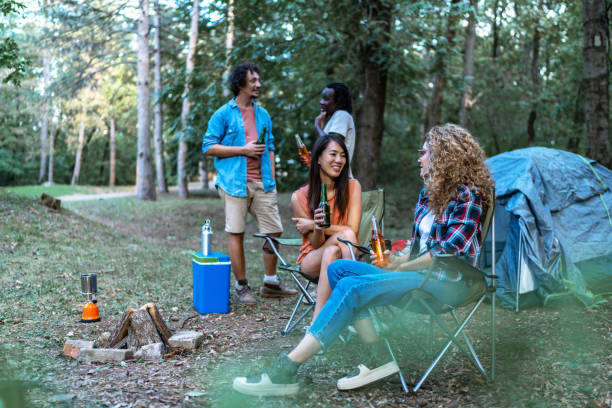istock Group of diverse friend having outdoors camping party together 1975461829