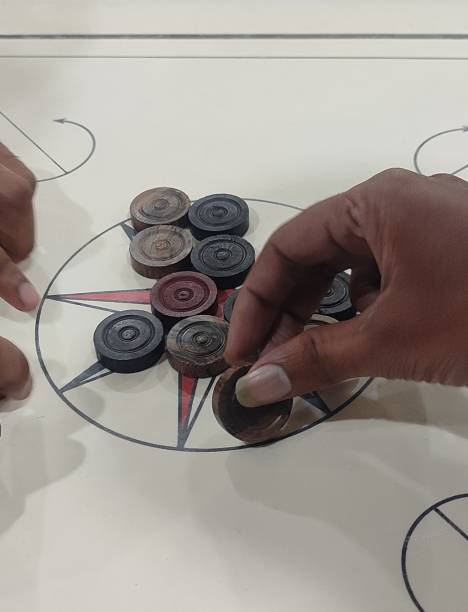 istock Carrom Board Playing Photography. Mens Playing Carrom 1975467066