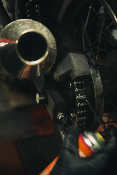 istock Motorcycle maintenance, lubricating chain, close-up 1975475499
