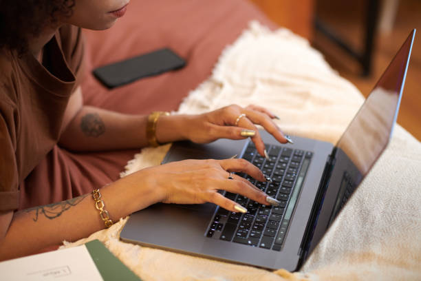 istock Hands of Wwoman Answering Emails 1975497790