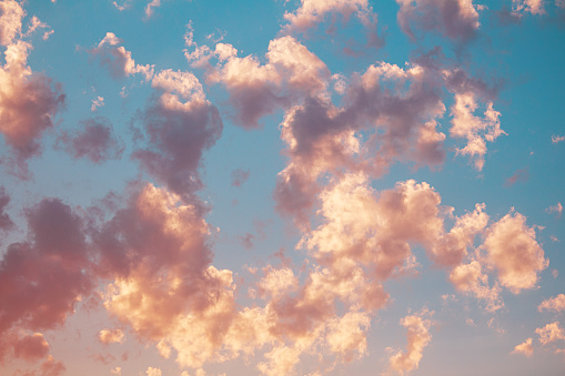 Light pink clouds on blue sky. Romantic sunset of day. Nature