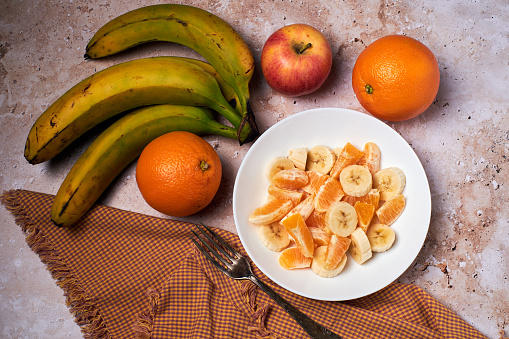 Breakfast of fruit salad, orange, banana and apple