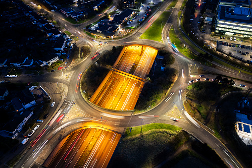Aerial view of roundabout and A1 M motorway passing underneath at night. Hatfield. Hertfordshire. England.