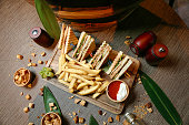 Wooden Tray With Half Sandwich and French Fries