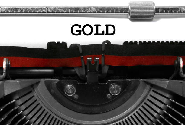 Text GOLD written with the vintage typewriter on white sheet