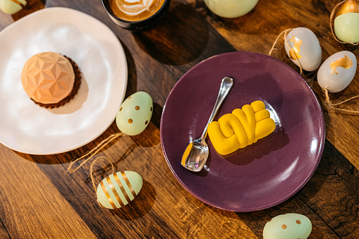 Mini desserts served with coffee on an Easter-themed table in a café.