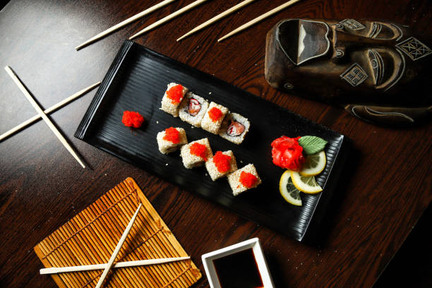 istock Freshly Plated Sushi With Chopsticks on Wooden Table 1975614978