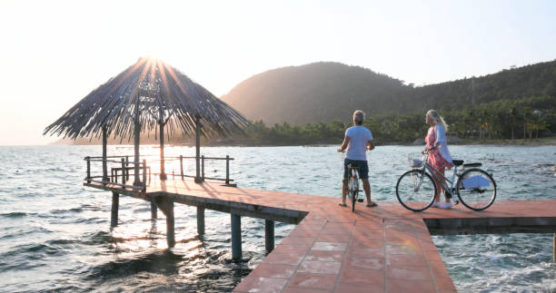 istock Couple pause with bicycles on pier 1975621900