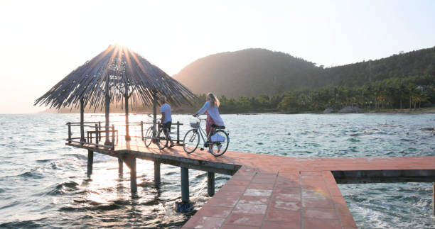 istock Couple pause with bicycles on pier 1975621901