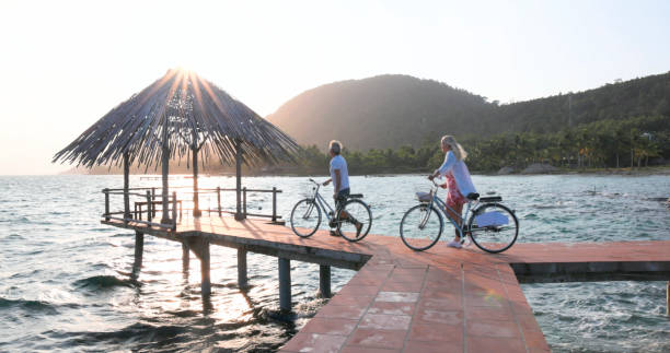 istock Couple pause with bicycles on pier 1975621906