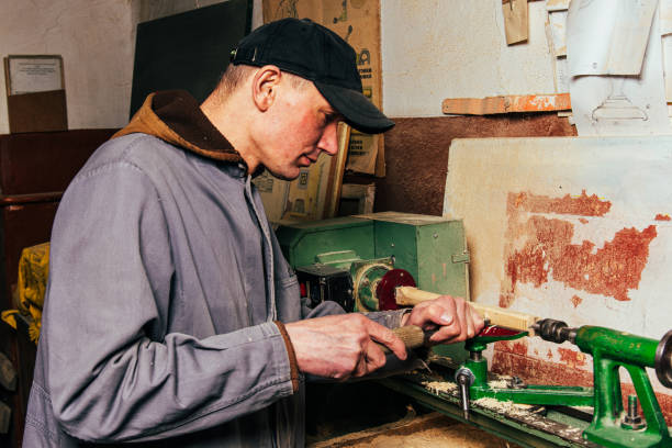 istock A carpenter works in a workshop with a saw, planer and various tools 1975652701