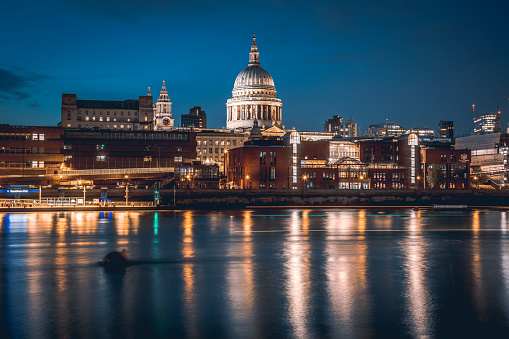 Long exposure shot of St Paul's Cathedral  in London at night after sunset with colorful  reflections in the River Thames in London City, England, United Kingdom