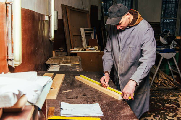 istock A carpenter works in a workshop with a saw, planer and various tools 1975653741
