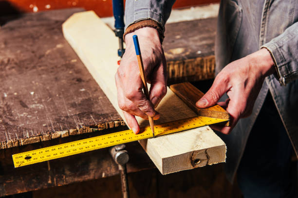 istock A carpenter works in a workshop with a saw, planer and various tools 1975654784