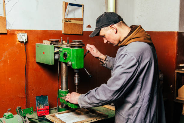 istock A carpenter works in a workshop with a saw, planer and various tools 1975655319