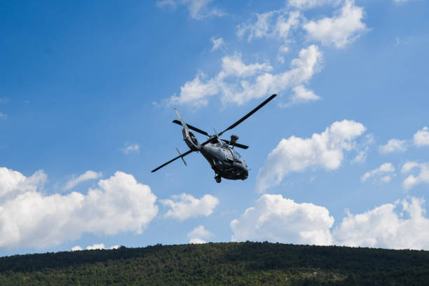 istock Military helicopter flying in the air. 1975682031