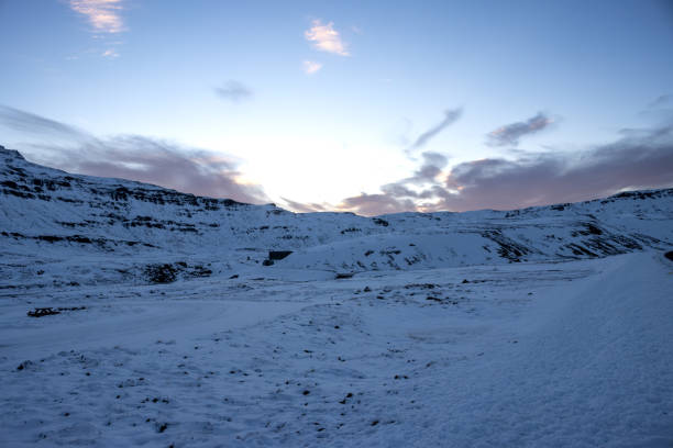 Majestic beauty of the mountains covered by snow in the autumn already. Touch of the colors on the sky in the early sunset. Seydisfjorur, East Iceland