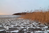 ice and white slush swaying on the surface of the lake