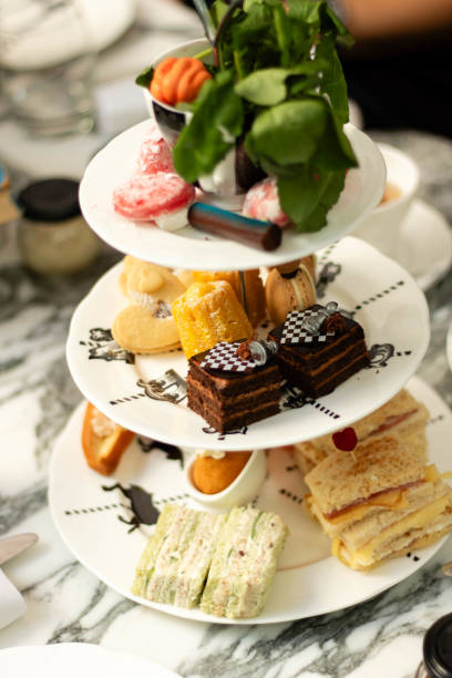 tiered plates of treats for engligh high tea - afternoon tea fotos imagens e fotografias de stock