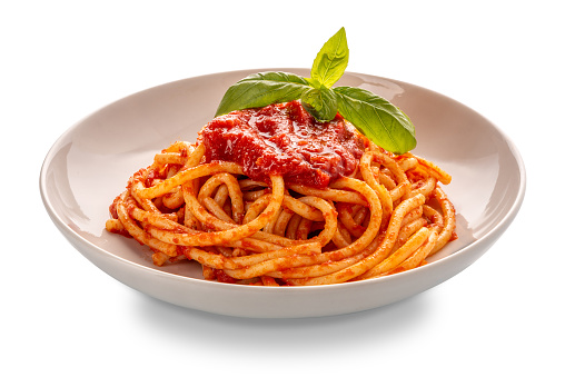 Bucatini pasta with tomato sauce and basil leaves in white plate isolated  with clipping Path included