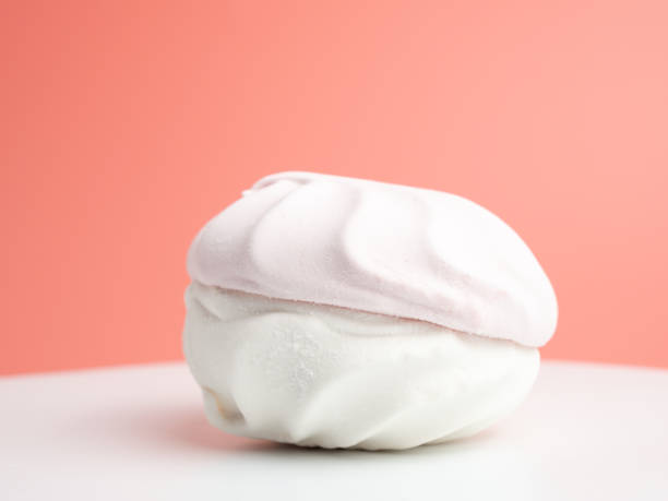 istock White and pink meringue cookies on a pink background. 1975727392