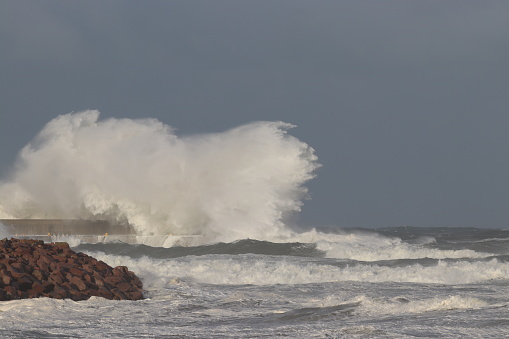 Stormy sea hitting breakwater