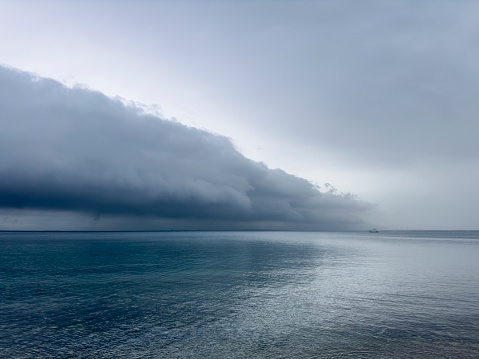 Storm clouds and calm sea. No people. Coast of Bozcaada in the northern Aegean Sea.