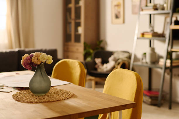 istock Vase with flowers on wooden table 1975852338
