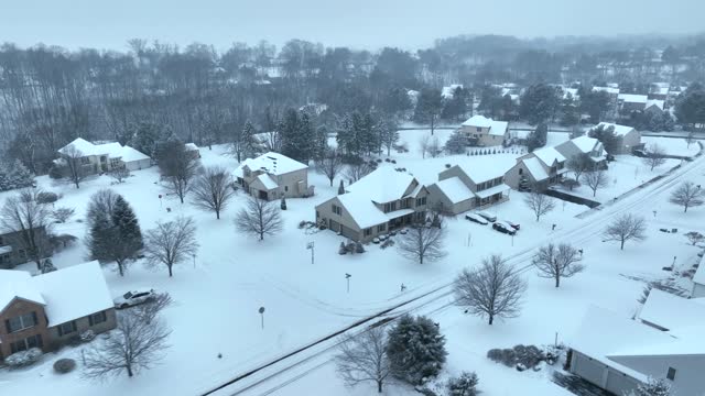 Aerial shot of mansions in winter. Snow covered American neighborhood houses.