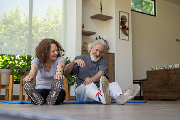istock An older couple exercising at home to stay active. 1975893879