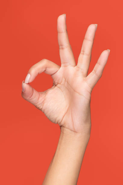 istock Isolated female hand making the OK gesture on an orange background 1975930127