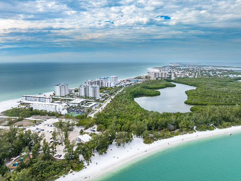 Aerial view of Lido Key near Sarasota, Florida with lagoon, mangroves, condos and beach.